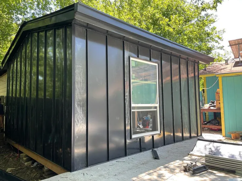 Black standing seam metal wall panels for Roof Inspection in Angleton