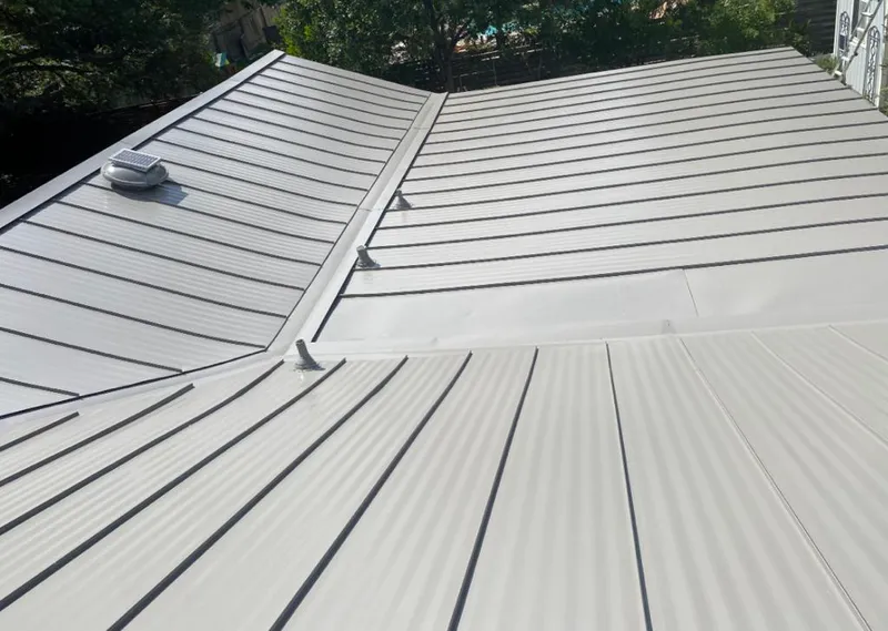 Solar attic fan installed on a metal roof for Roof Ventilation in Angleton